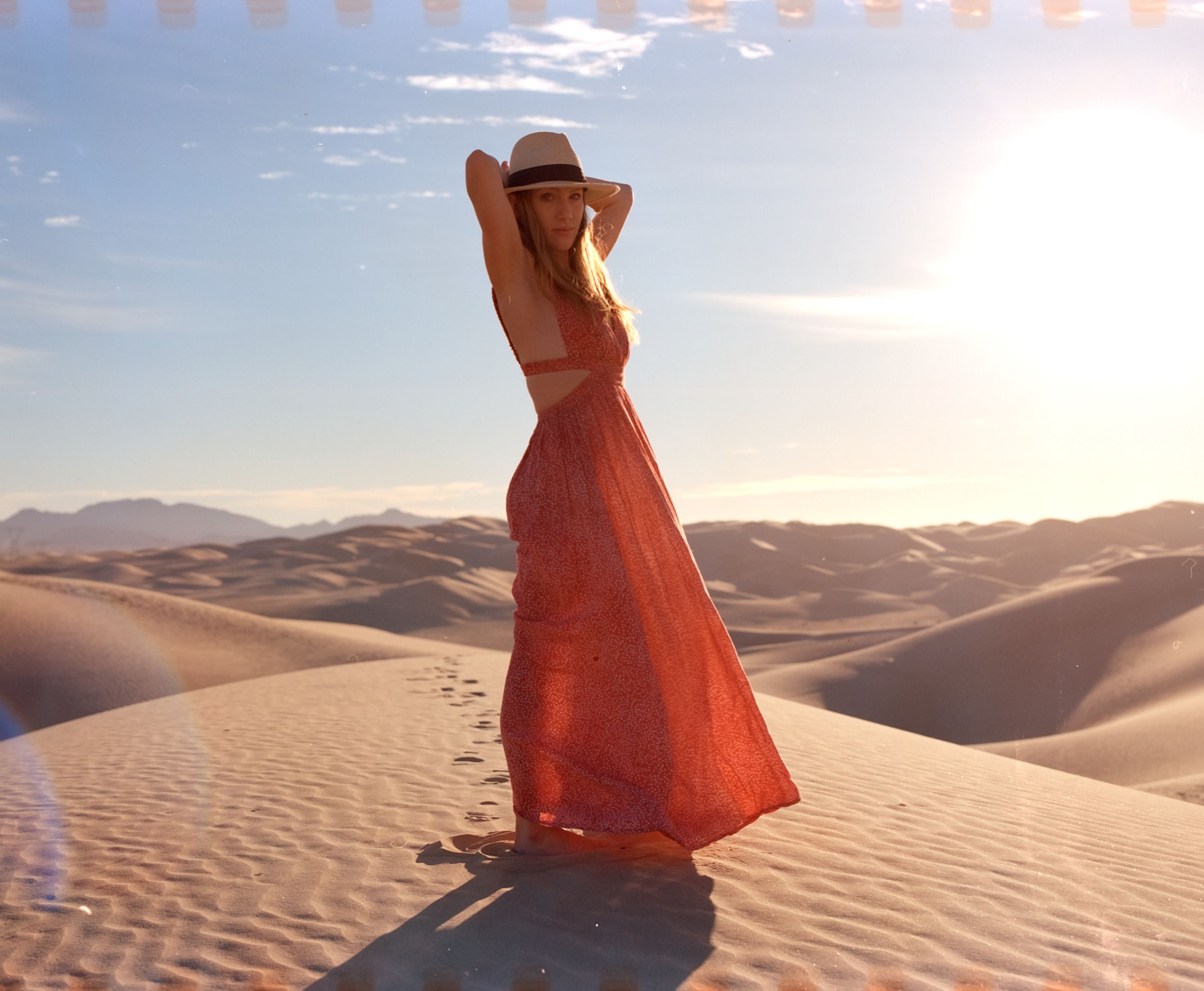 Color analog photograph shot on Mamiya RZ67 Pro II and Kodak Vision3 250D with Sekor 90mm in Imperial Sand Dunes by TheAnalogPhotographer (United States). [Fashion]